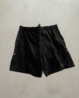 Black Champion woven training shorts laid flat, front, with tonal mesh side panels and the Champion C at the hem.